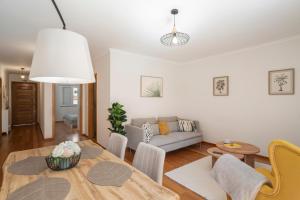 a living room with a table and a couch at On the south coast of the island Ribeira Brava I in Ribeira Brava