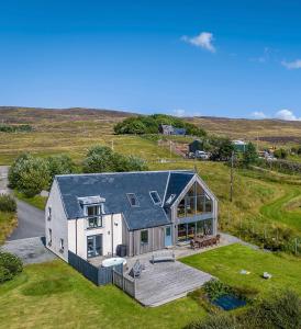 an aerial view of a house in a field at Stac Polly Lodge in Achiltibuie