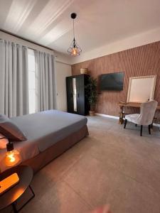 a bedroom with a bed and a table and a chair at Appartamento Dolce Vita - Parking & Self Check-in in Como