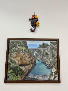a framed picture of a river and a bridge at Il Borgo in Agerola