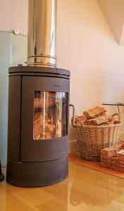 a black stove with a basket of bread at Stac Polly Lodge in Achiltibuie