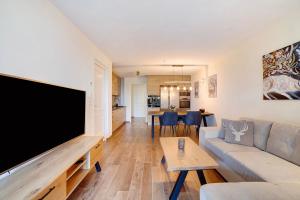 a living room with a large flat screen tv at Apartement Panoramaresidence in Avelengo