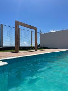 a swimming pool with a fence and blue water at Solar Calixto in Belém