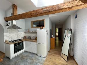 a kitchen with a white refrigerator and a sink at SPOKO Chatka in Rypin