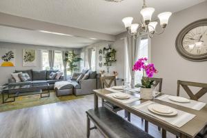 a living room with a table and a dining room at Minneapolis Home Mins From US Bank Stadium and More in Golden Valley