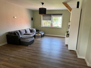 Una sala de estar con un sofá y una ventana. en Loft am See, en Dargun