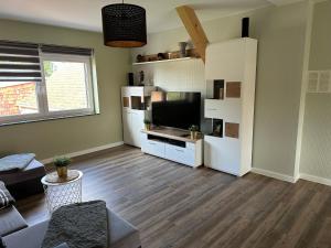 a living room with a couch and a television at Loft am See in Dargun