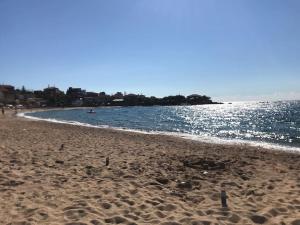 a sandy beach with a body of water at Villa Pantazi in Riglia