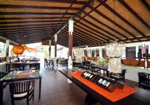 a restaurant with tables and chairs and a dining room at Absolute Scuba Bali Dive Resort in Padangbai