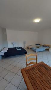 a room with two beds and a table and a chair at Villesse Centro 