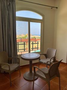 une chambre avec une table, des chaises et une fenêtre dans l'établissement Deep Ashri Star House Hotel, à Marsa Alam