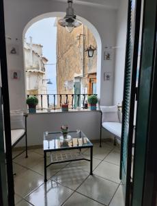 a room with a table and two chairs and a window at YourHome - La Dimora Di Nonna Angela in Positano