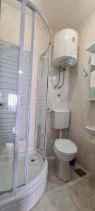 a bathroom with a shower and a toilet and a sink at Apartment Next to the sea in Jelsa