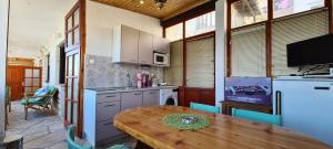 a kitchen with a wooden table and a dining room at Apartment Next to the sea in Jelsa