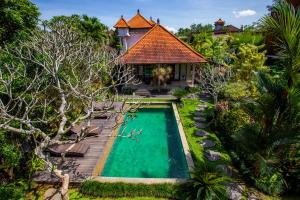 an aerial view of a villa with a swimming pool and a house at Lili Cottage Ubud in Ubud
