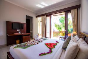 Postel nebo postele na pokoji v ubytování Lili Cottage Ubud + 32 fotografií