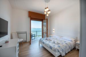 a bedroom with a bed and a view of the ocean at You and the Sea in Savona