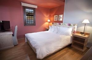 Posteľ alebo postele v izbe v ubytovaní Kazarma Hotel