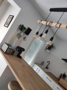a kitchen with a wooden counter top in a room at Apartamentos La Casa del Maestro in Alhama de Aragón