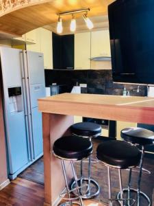 a kitchen with a counter with stools in it at Joy City Stay Republicii 19 in Timişoara
