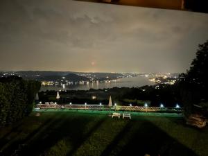 a park with a view of a city at night at Villa Marisa in Nebbiuno
