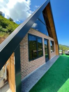 a view of a house with a large window at Hidden Garden Bungalow in Trabzon