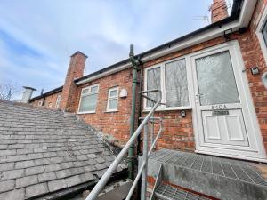 a house with a roof that has a door at 12min to City - FREE Parking - Christie NHS - Contractor Friendly - IRWELL STAYS in Manchester