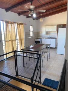 a kitchen with a table and chairs in a room at Departamento termal in Federación