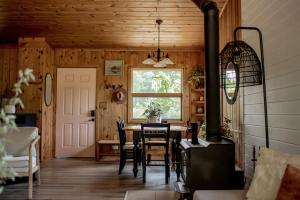 a dining room with a table and chairs and a window at Bay Point Hideaway in the Woods in Beulah