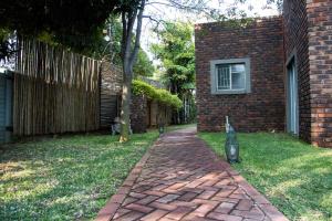 a brick walkway in front of a brick house at Zoete Rust Guesthouses in Lephalale