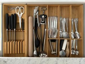 a wooden drawer filled with utensils in a kitchen at Loft Conversion in Northern Quarter in Manchester