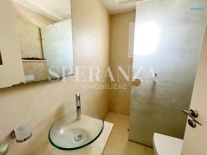 a bathroom with a glass sink and a shower at Appartement cerise S+2 in Nabeul