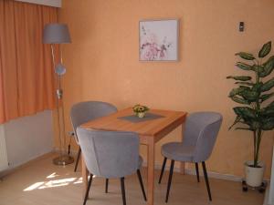 einem Esstisch mit 4 Stühlen und einer Pflanze in der Unterkunft Ferienwohnungen Pook in Wernigerode