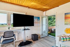 a living room with a flat screen tv on a wall at Ferienwohnung Burgblick in Sinsheim