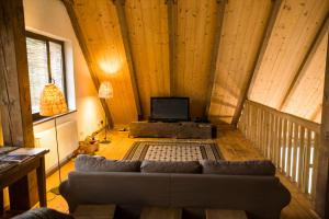 a living room with a couch and a tv at Viscri 125 in Viscri