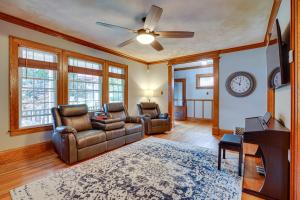 a living room with two couches and a ceiling fan at Utica Vacation Rental Gas Grill and Spacious Yard! in Utica
