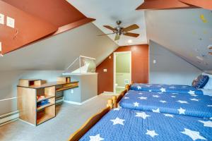 a bedroom with a blue bed with stars on it at Utica Vacation Rental Gas Grill and Spacious Yard! in Utica