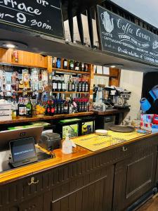 a bar with a laptop on top of it at Crown & Cushion Hotel in Chipping Norton