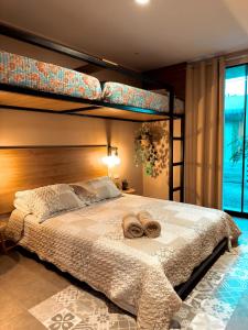 a bedroom with a bed with two towels on it at Desert Lodges - La Terracota in Ica