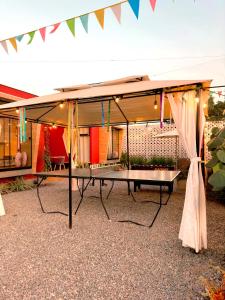 een picknicktafel onder een paviljoen met een tent bij Desert Lodges - La Terracota in Ica