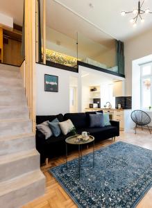 a living room with a black couch and a table at KIRÁLY DOWNTOWN APARTMENT in Budapest