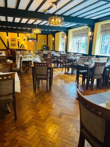 a restaurant with wooden floors and tables and chairs at Crown & Cushion Hotel in Chipping Norton