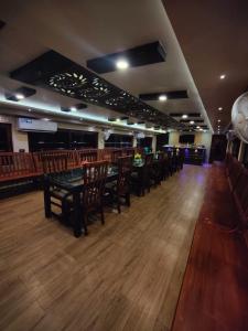 a dining room with tables and chairs in a restaurant at Kalappura Houseboats & Tours in Alleppey