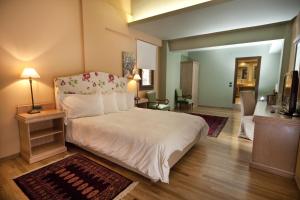 Posteľ alebo postele v izbe v ubytovaní Kazarma Hotel