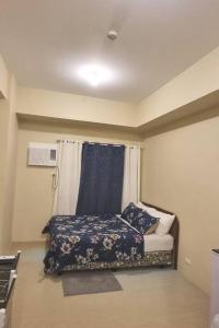 a small room with a bed and a window at Fully furnishd Avida condo 2(wi-fi netflx disney+) in Cagayan de Oro