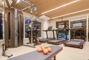 a gym with several treadmills and orange balls on a table at Radisson Pinheiros in Sao Paulo