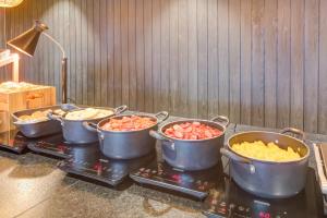 a group of pots of food on a stove at Radisson Pinheiros in São Paulo