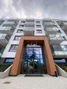 a tall white building with a large window at Bel Mare Aqua Resort 508 in Międzyzdroje