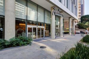 a store front of a building with glass windows at Radisson Pinheiros in São Paulo