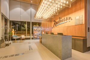 a lobby of a restaurant with a reception desk at Radisson Pinheiros in Sao Paulo
